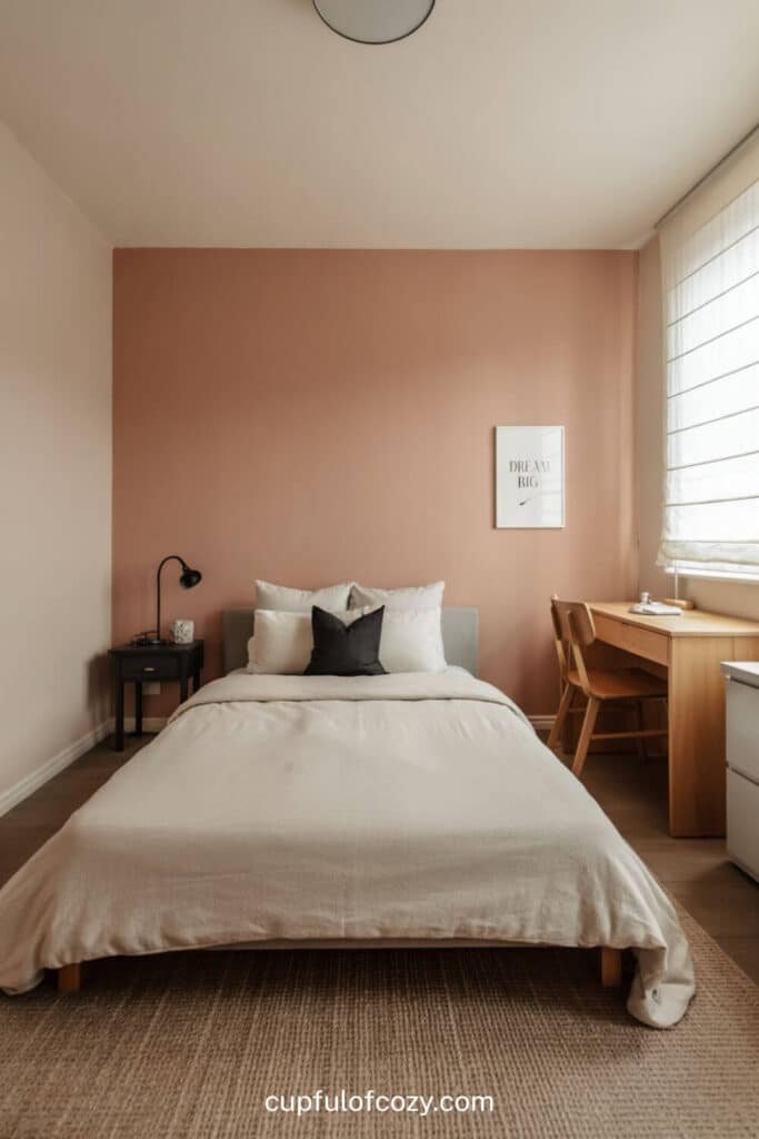 Blush Pink Accent Wall with Natural Wood Furniture